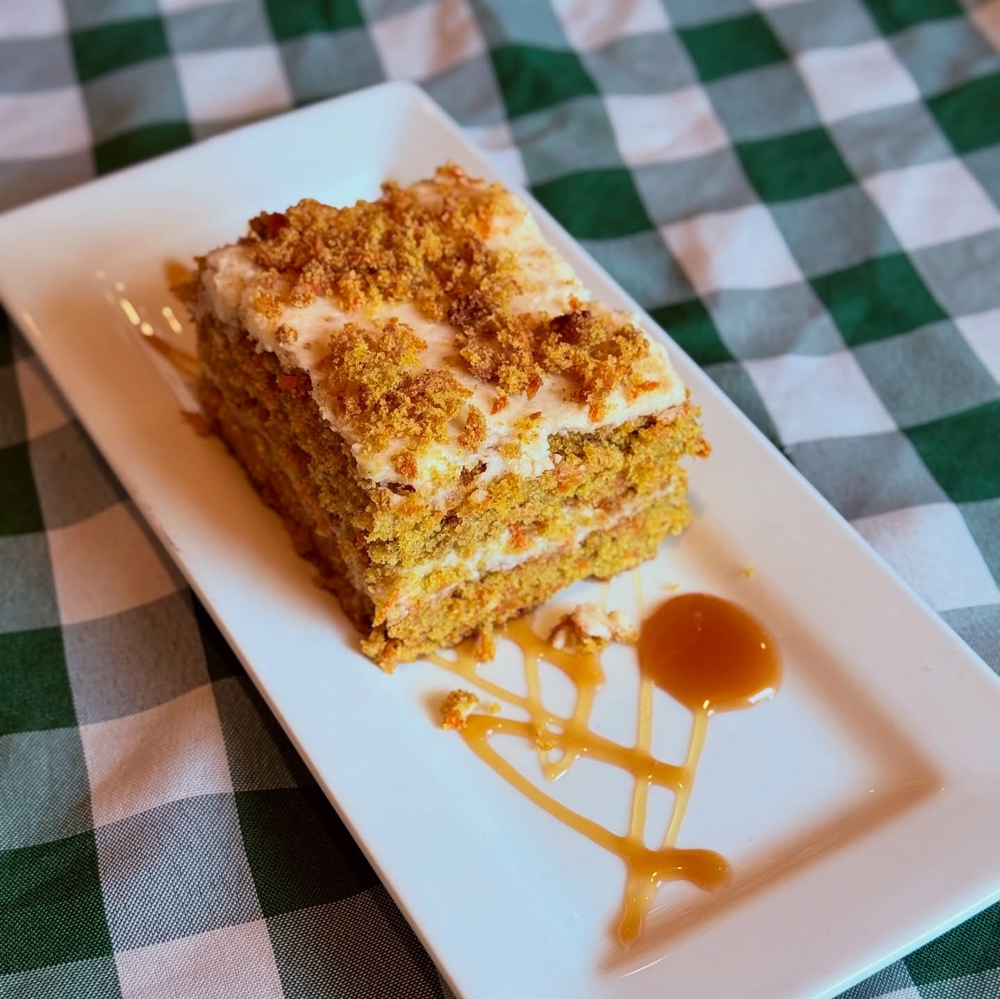 Carrot cake with caramel on a gingham cloth, made in house