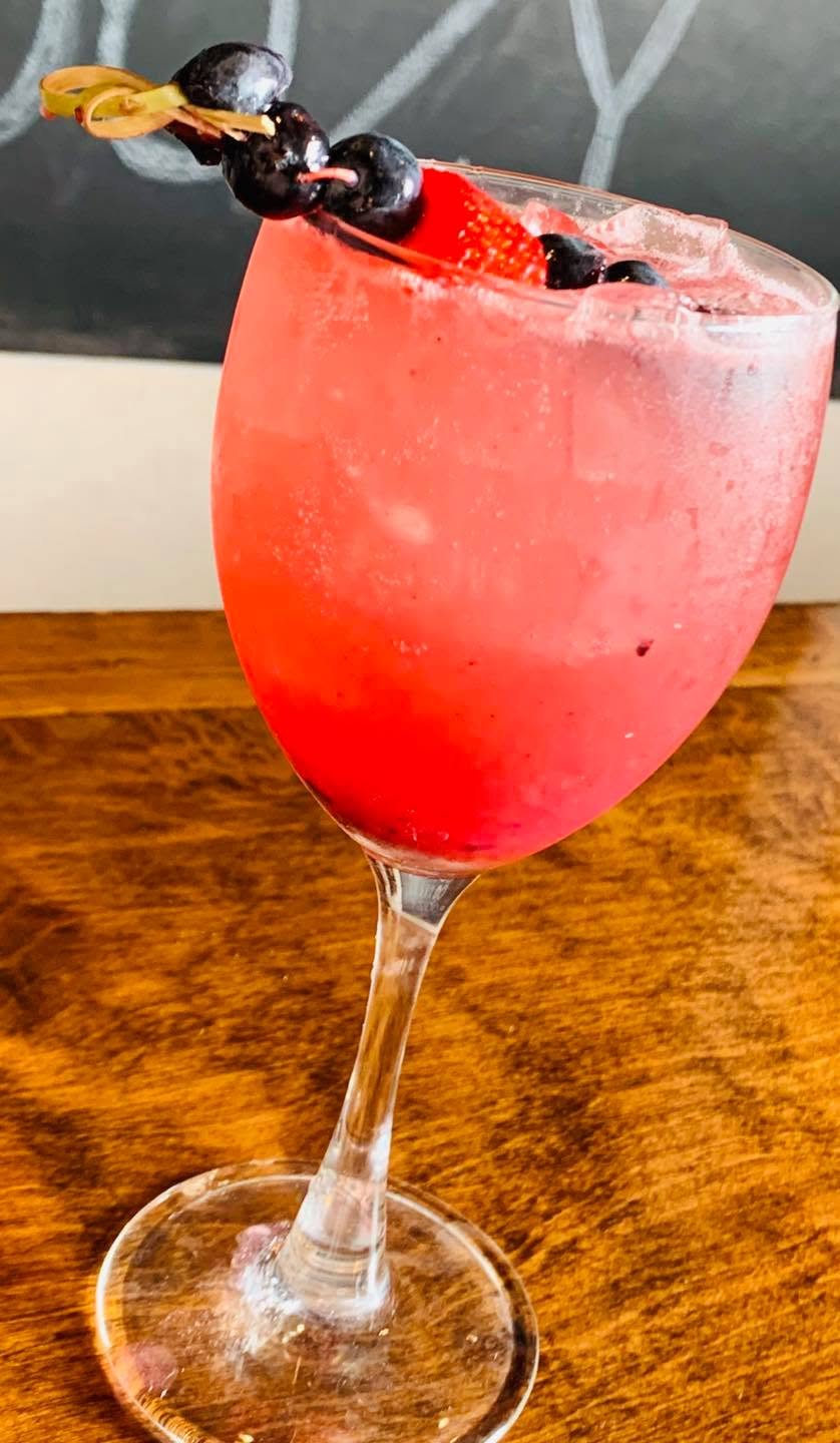 A strawberry cocktail in a wine glass