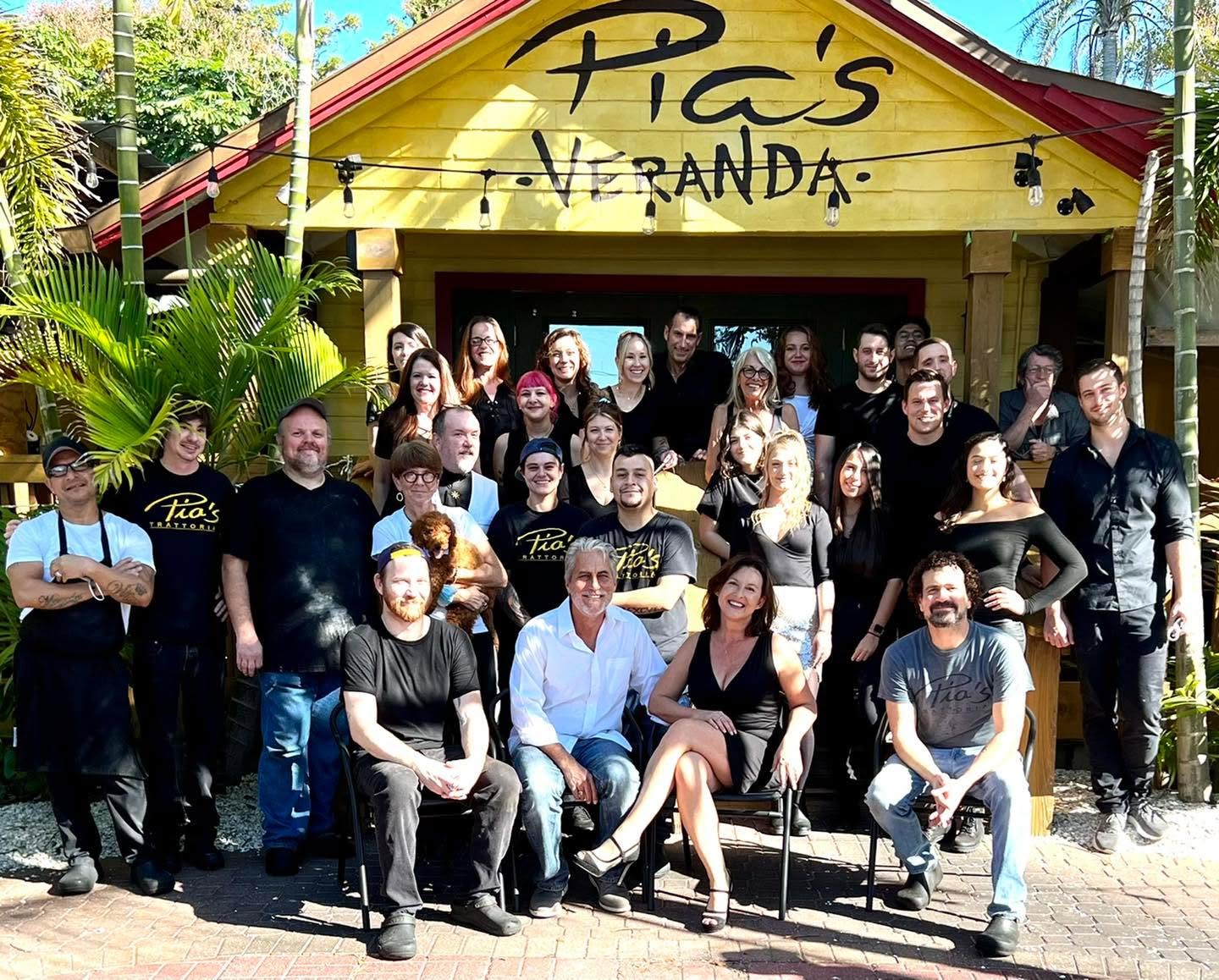 The Veranda team gathered under the Pia's Veranda sign