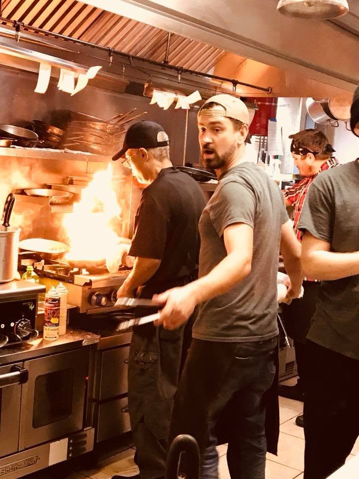 Cooks working the line on a busy night in the Trattoria kitchen