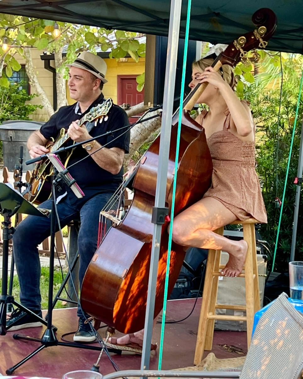 A guitarist and a bassist playing a set on the Veranda stage