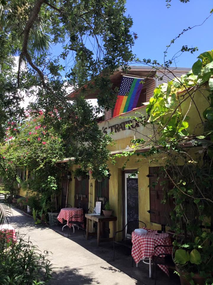 Gingham tables tucked along the Trattoria's stucco side path