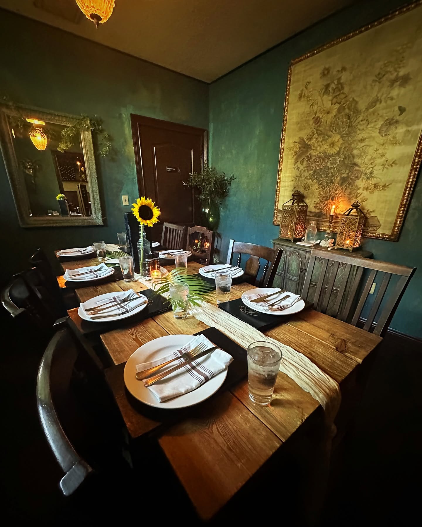The teal private room set with sunflowers and candles
