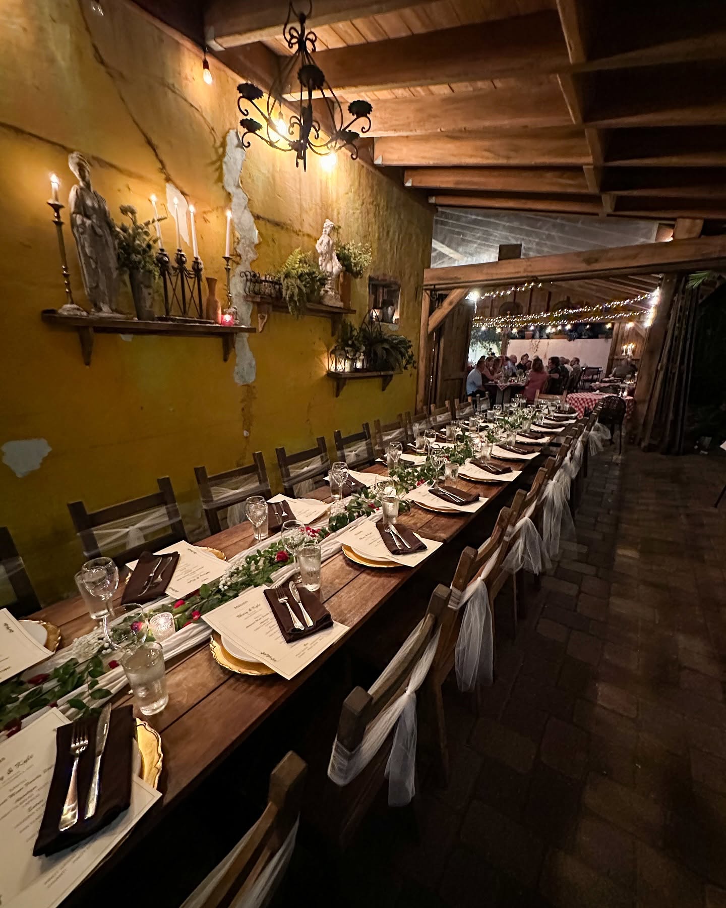 A long candlelit table down the Trattoria's yellow-walled patio room