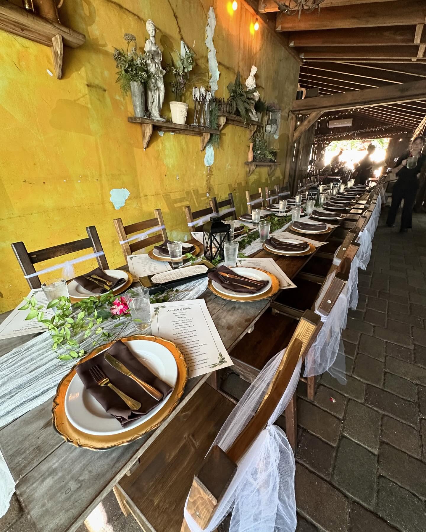 A set table along the patio's yellow wall