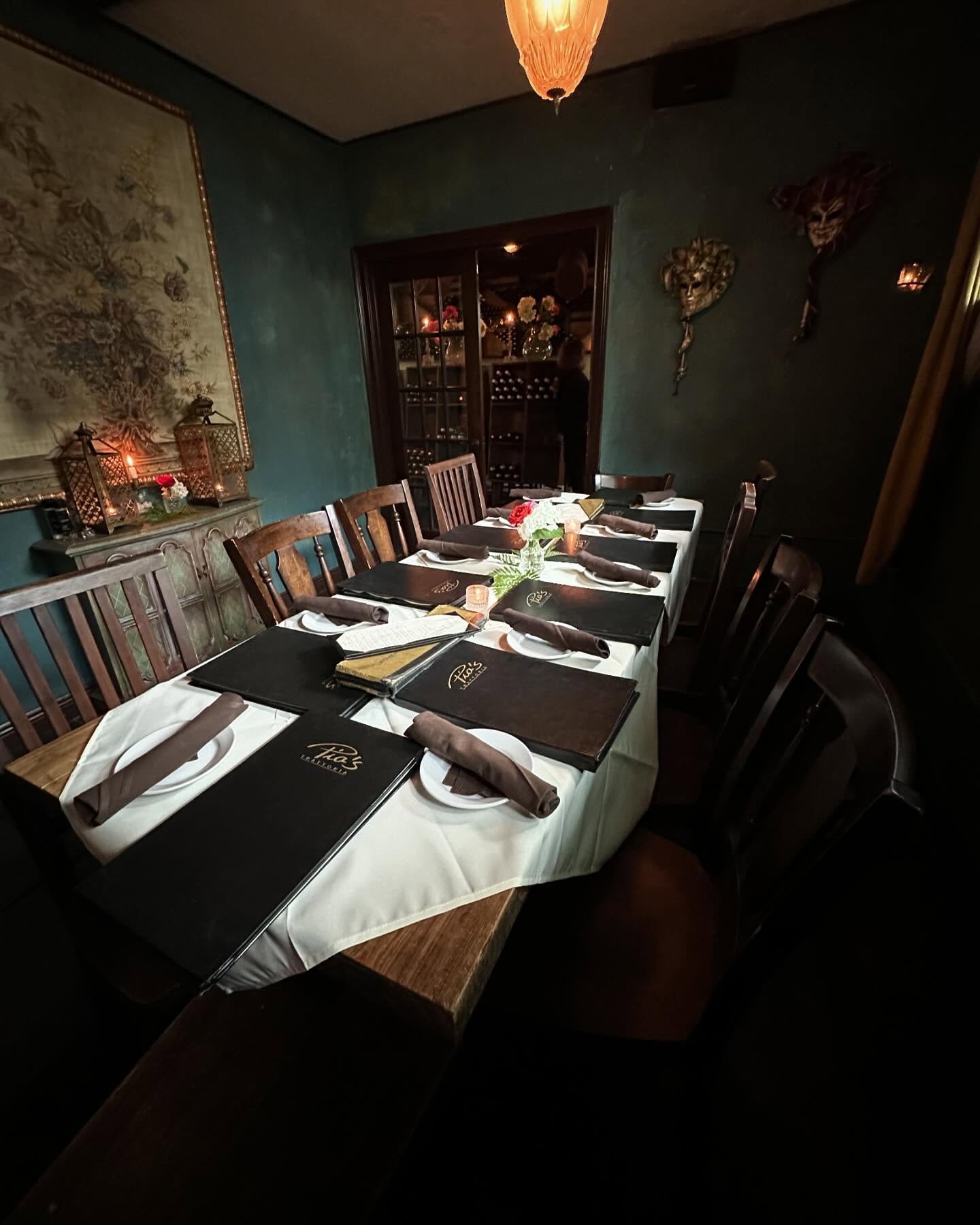 The teal private room's long table ready for guests