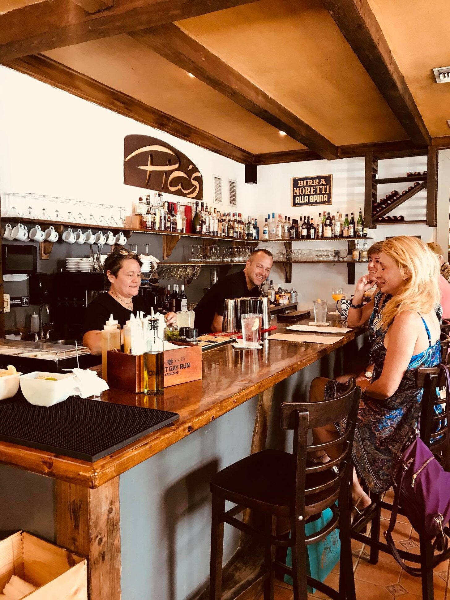 Guests and staff at the Trattoria's small bar