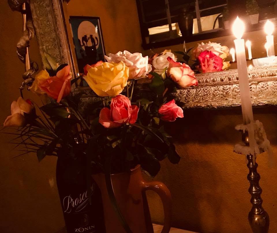 Roses and taper candles on a Trattoria table