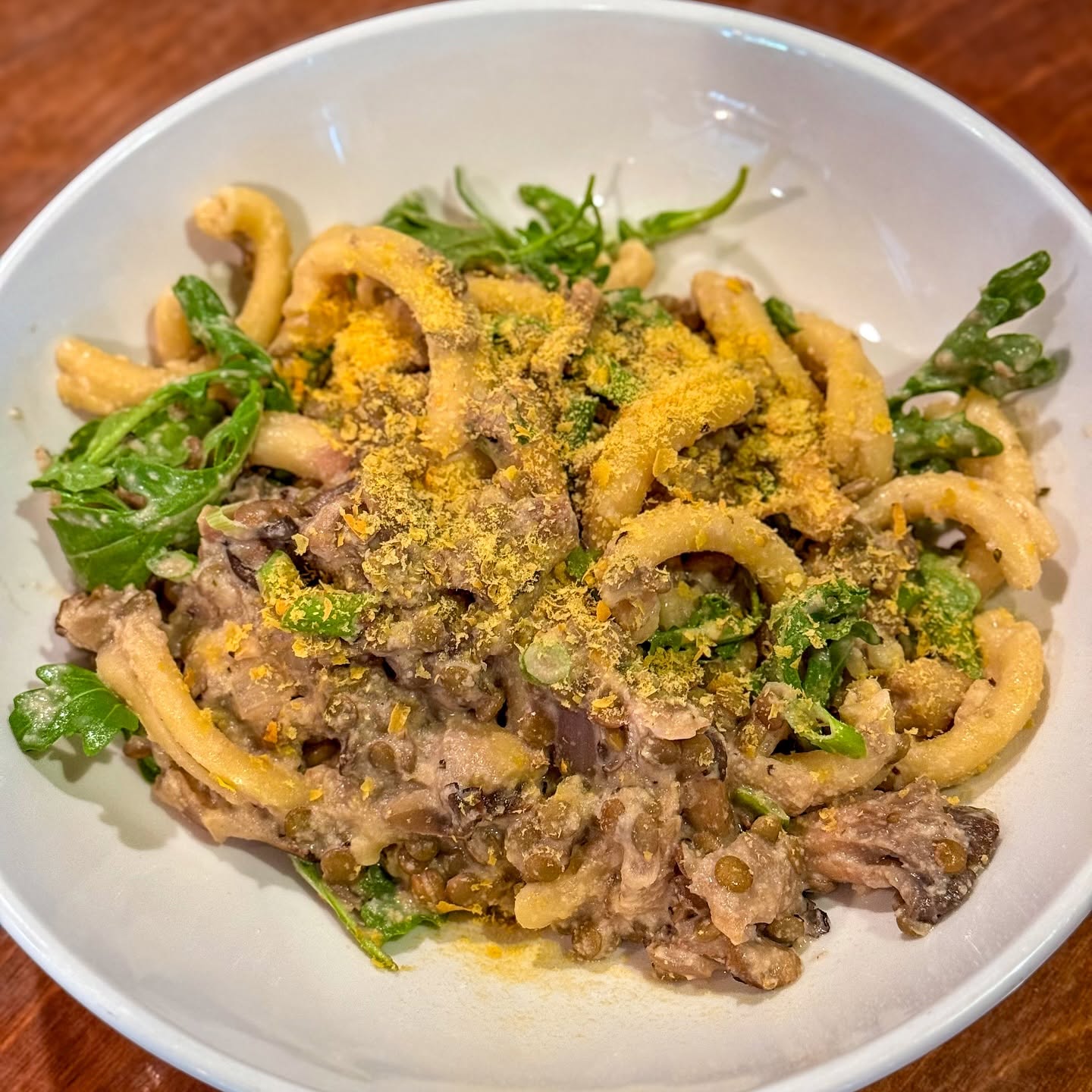 Fresh pasta with wild mushrooms and pistachio, on the Trattoria's dark wood table